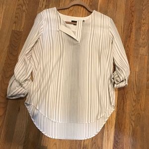 Cream blouse with black stripes.